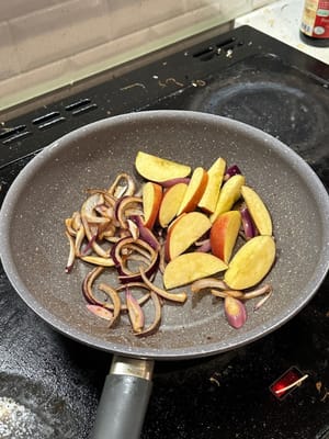 In the same pan, sear onion until softens and add in apple slices