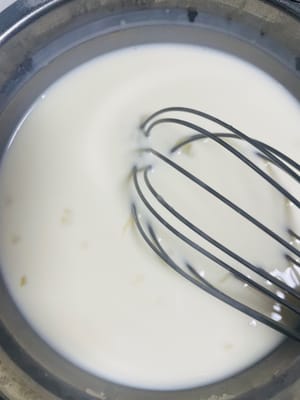 Pour 300g of milk and 50g of whipping cream into the egg white and sugar solution, stirring slowly while pouring to allow the three to fully blend.