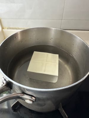 Put tofu in cold water and boil for 3 minutes.