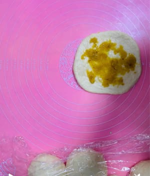 Stuffing and shaping: Take the dough and wrap the pineapple filling like making dumplings, with the seam facing down, and shape into small round balls.