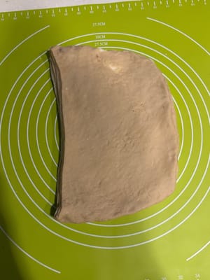 หมุนแป้ง 90 องศา แล้วรีดให้เป็นแผ่นยาวอีกครั้ง