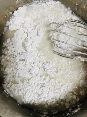Continue to add the cake flour, stirring continuously in one direction until the flour and sugar solution are fully blended to form a fine, particle-free paste.