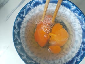 Crack the eggs into a bowl.