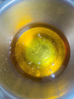 1. Make the mooncake wrapper: First, pour 8g of lye water, 220g of invert sugar syrup, and 60g of peanut oil into a bowl. Stir vigorously with chopsticks to combine.