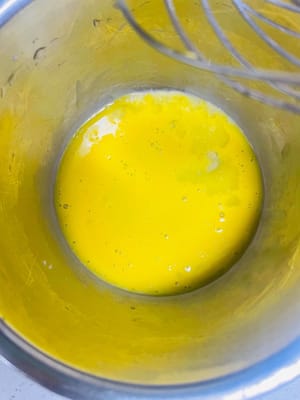 5. Egg Mixing (The Secret to Shiny Mooncakes)
Take one egg yolk, whisk it, add a few drops of water, and then a drop of invert sugar. Stir thoroughly, then sieve and set aside.