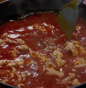 Now turn on low heat and evenly add the meat slices, gently push them a few times, and cook for one minute.