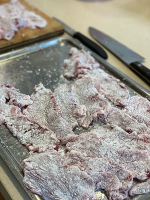 Cubra ligeramente las lonchas de cerdo con fécula de patata. Esto ayudará a retener los jugos y a que la salsa se adhiera mejor a las lonchas.