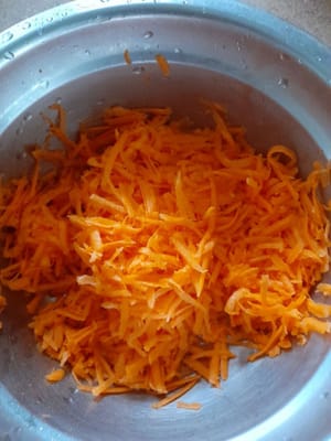 Then grate the carrots, finely sliced spring onions