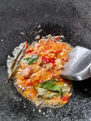 Saute the ground spices until fragrant, add galangal, bay leaves, and lime leaves.