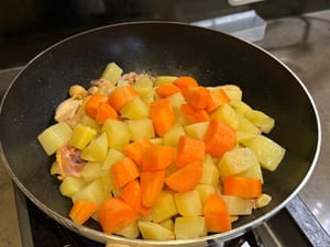 Simmer potatoes and carrots together for 15 minutes.