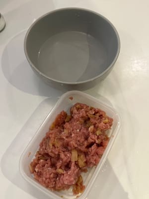 After mixing well, add in about 1 tablespoon of water to the pork mixture and mix allow water is absorbed by the pork. Repeat this process for 3 times