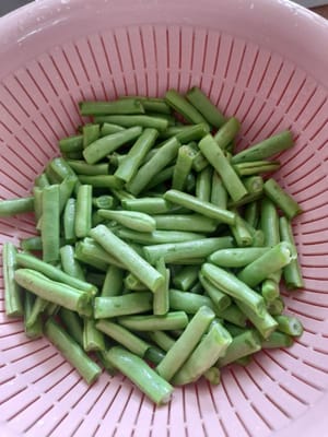 Préparez les autres ingrédients. Pour les haricots verts, épluchez-les des deux côtés, lavez-les bien, puis coupez-les en tranches dans le sens de la longueur.