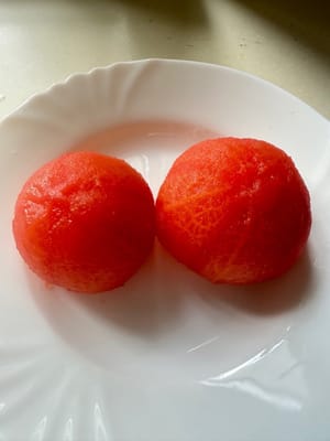 Wash the tomatoes, put them in a container, add boiling water and cover. Soak for 15 minutes, remove them, let cool and peel them.