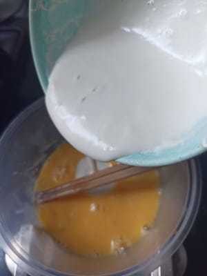 将湿面粉加入装有鸡蛋的碗中，