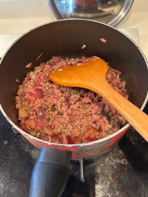 Then add in the minced beef, fry together until the beef is browned