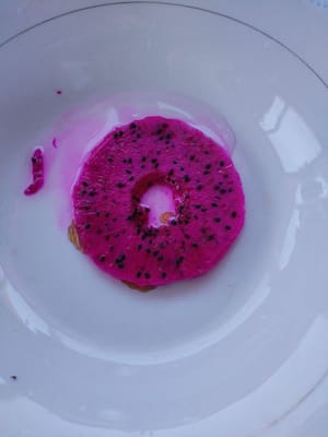 Cut the dragon fruit in half, use a round spoon to make a hole in the center of one half of the dragon fruit, then slice it and set aside.