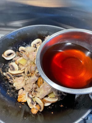 翻炒均勻後，加入紹興酒及水。
