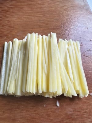 Cut the potatoes into thin strips and add a little salt.