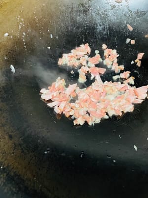 Add bacon and fry over low heat until golden.