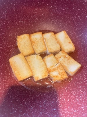 Cut the tofu. Heat the pan and add oil. Fry the tofu until both sides are slightly golden.