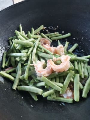 then add the green beans and stir for a while.