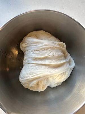 Luego, gira 90 grados y haz lo mismo: estira el borde de la masa en la dirección de las 12 en punto y dóblalo hacia abajo hasta las 6 en punto.