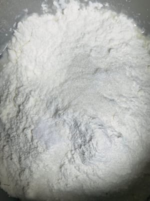Add water and yeast to a bowl and mix well. Then add 500 grams of flour (reserve 80 grams for later use), salt and sugar and knead until the surface is smooth.