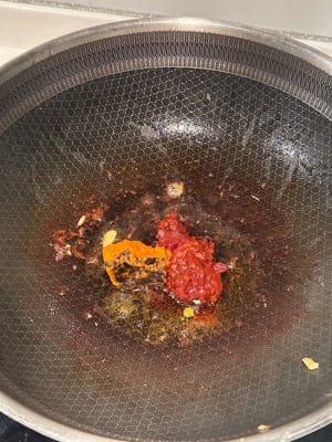 Turn the heat down, add the spicy bean paste and hot pot base until melted