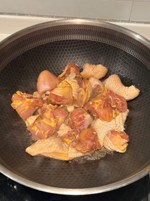 In a heated pan with oil, start pan frying the chicken until browned. Remove from pan and reserve