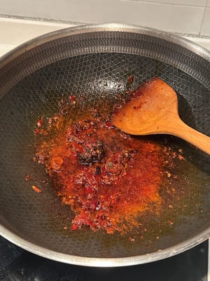 Turn the heat down, add the spicy bean paste and hot pot base until melted
