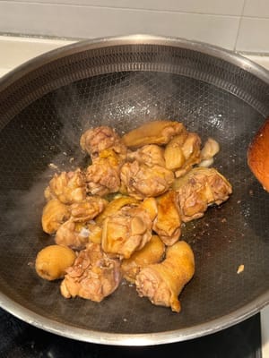 In a heated pan with oil, start pan frying the chicken until browned. Remove from pan and reserve