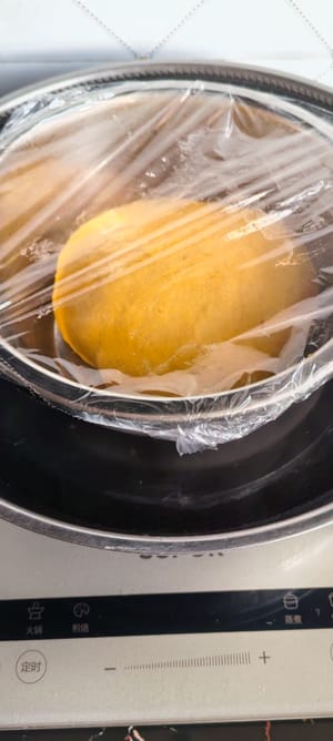 ใส่แป้งลงในภาชนะ ปิดด้วยพลาสติกแรป แล้วแช่ในน้ำอุ่น 40 องศาเซลเซียส เพื่อพักแป้งประมาณ 40-50 นาที