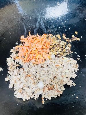 1. Grease a wok with oil, add the ground pork, and simmer over low heat, covered, until the pork is cooked through to prevent it from sticking.
2. Stir-fry the pork until golden brown. Add the chopped garlic (or onion) and sauté until fragrant. Remove the garlic or onion.
3. Pour a spoonful of cooking wine along the edge of the wok and stir-fry. Add the diced shiitake mushrooms and dried shrimp and stir-fry briefly. Then add the diced carrots, green beans, and corn and stir-fry until combined. (I used to just use glutinous rice, minced pork, and shiitake mushrooms, and it was delicious. Adding the diced vegetables gives it a richer texture, but it's less sticky.)