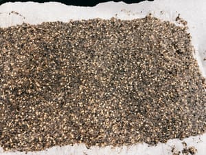 把拌勻的麵糊鋪在烤盤上，儘量鋪薄，放進150度的烤箱烤8-9分鐘取出切成小塊，這個時機餅是軟的，很容易切。