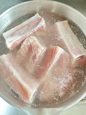 To clean the pork ribs, rub them with corn starch and salt, and let soak for 10 minutes