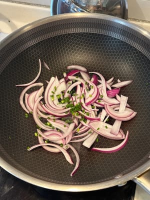 In a heated pan, fry the onion and garlic until softens