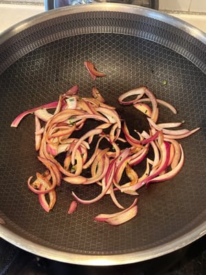 In a heated pan, fry the onion and garlic until softens