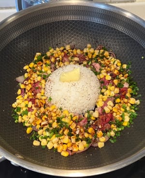 Add in the sauce, cheese and a scoop of butter on the rice. Turn up to medium heat