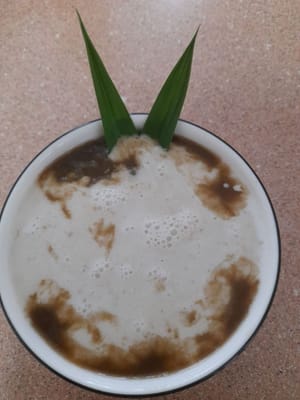Porridge is ready to be served with coconut milk sauce.
