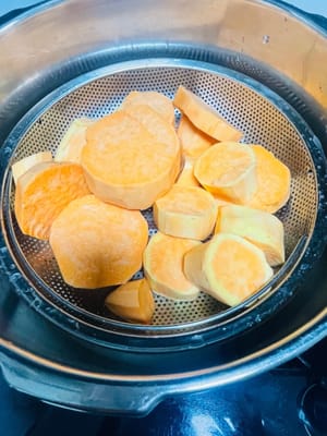 さつまいもの皮をむき、厚めにスライスします。鍋で蒸し、中まで火が通るまで（箸で簡単に刺せるくらい）蒸します。私は圧力鍋を使い、圧力を抜いてから10分ほど蒸しました。