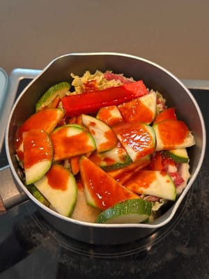 Pour in the prepared sauce. Start cooking on medium low heat with lid on. (no need to add any water to the pot)