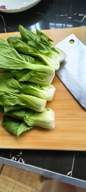 先将小白菜清洗干净，对半切开