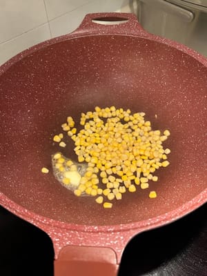 In the same pan, add a scoop of butter, and fry the corns slightly. Reserve