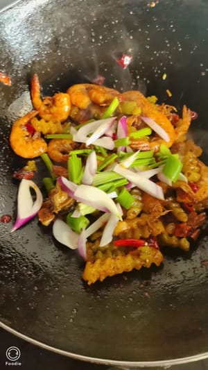 After stir-frying until fragrant, add the shrimp and side dishes, stir-fry over high heat until the sauce is fragrant, finally sprinkle with shredded onions and celery, stir-fry again until evenly mixed, and it's ready to serve.