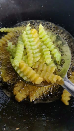 Add potato strips and lettuce strips, gently stir and fry until cooked through. Remove and set aside.