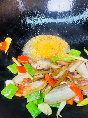 Tumis: Masukkan kembali daging perut babi yang sudah kecoklatan ke dalam wajan, tambahkan cabai yang sudah dihaluskan, dan tumis dengan api kecil selama satu menit. Wajan akan mendesis dan mengeluarkan aroma yang kaya. Bagi yang menyukai rasa yang lebih kuat, tambahkan satu sendok pasta kacang cabai Pixian; rasa gurih, pedas, dan lezat akan langsung terasa lebih intens.

Bisakah Anda mencium aromanya?