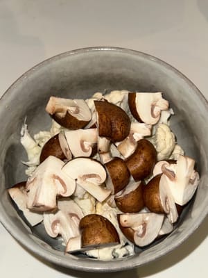 In a bowl, cut and prepare vegetables into bite size. Mix in salt, pepper, paprika, mixed herbs, half the minced garlic, grated cheese and olive oil