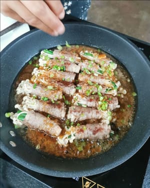 then add sliced spring onions