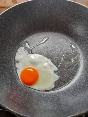 Fry the eggs until cooked, then remove and set aside.