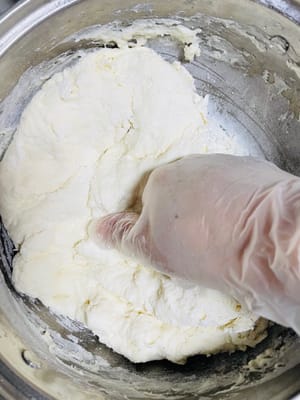 Kneading the dough is key.
Put on gloves and start kneading the dough. Remember, it's 